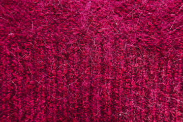 The texture of the bottom of the knitted sweater is red. Knitted sweater in red.