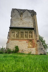 Fototapeta premium Medieval ruin monastery Wall of Anhausen, with Epitaph Statues, in Tauber Valley, Bavaria, South Germany