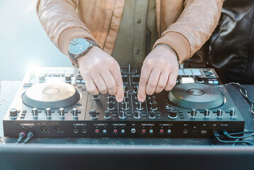 Disc jockey hands playing music for tourist people at beach party outdoor - Live event, music and fun concept - Entertainment and party concept