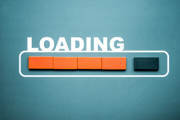 Wooden stick blocks with the word LOADING in loading bar progress. Concept loading.