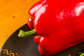a freshest red paprika, bell pepper in ceramic plate