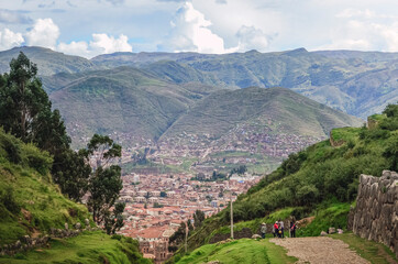 Aerial view of Cusco city landscape surrounded by mountains from the Sacsayhuaman Inca archaeological site valley and ancient fortress outside the city. Peru, South America