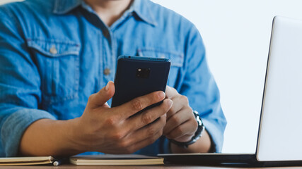 Close-up male hands with smartphone.