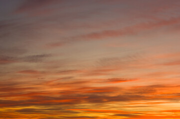 Landscape with dramatic light - beautiful golden sunset with saturated sky and clouds.