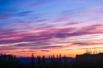 Landscape with dramatic light - beautiful golden sunset with saturated sky and clouds.
