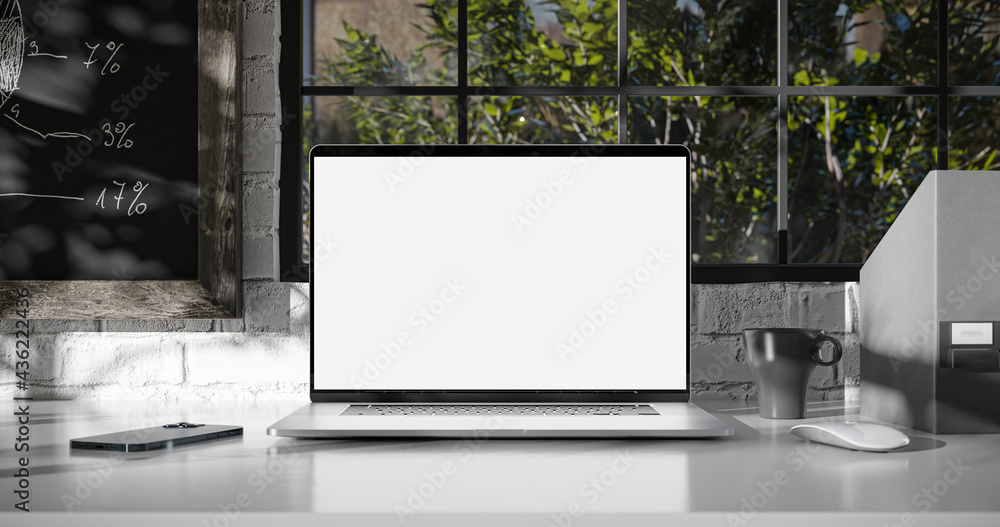 Poster laptop with the blank screen on the office table. window with trees in the background
