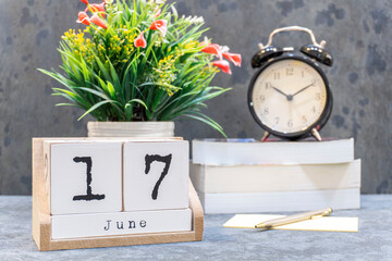 June 17th. June 17 wooden cube calendar with blur objects on background.