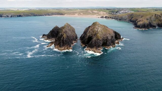 Holywell bay islands also know as gull or carters rocks in cornwall england uk aerial drone