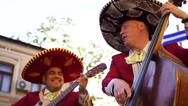 Mexican musicians mariachi band street concert	