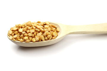 dried peas in a wooden spoon isolated on white background