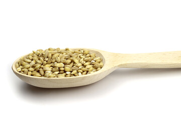 pearl barley in a wooden spoon isolated on white background