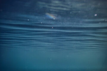 ocean water blue background underwater rays sun / abstract blue background nature water