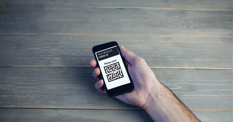 Composition of man holding smartphone with covid 19 test and qr code
