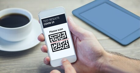 Composition of man holding smartphone with covid 19 test and qr code