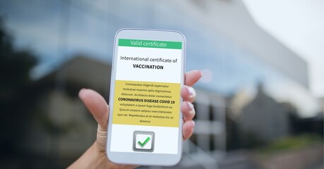 Composition of woman holding smartphone with covid 19 international certificate of vaccination