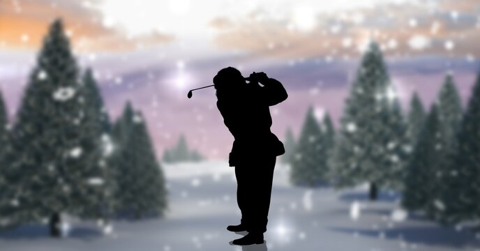 Composition of silhouette of santa claus playing golf over winter landscape