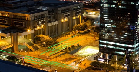 Composition of network of light trails and connections over cityscape at night