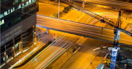 Composition of network of light trails and connections over cityscape at night