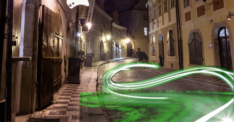 Composition of network of green light trails and connections over street at night - Powered by Adobe
