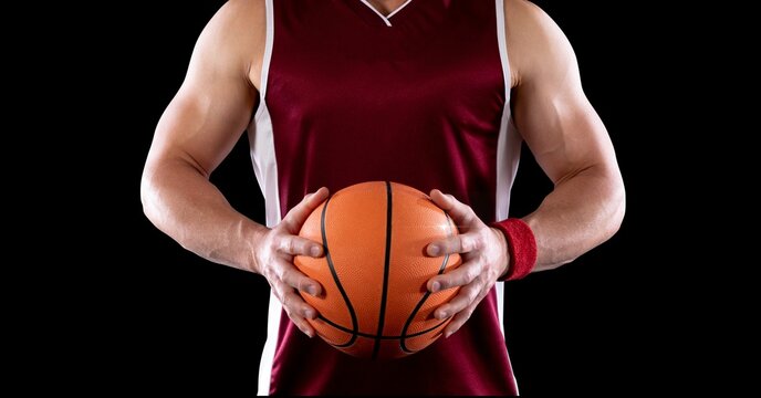 Composition of midsection of male basketball player with ball and copy space on black background