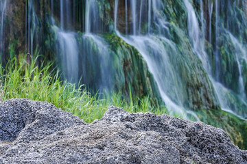 Naklejka na ściany i meble スローシャッターで撮影した涼しげな滝の背景