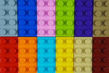 Many toy blocks of different colors, forming one large square shape.