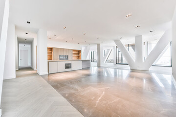 Interior of penthouse apartment with parquet and marble flooring and minimalist kitchen with wooden cabinets