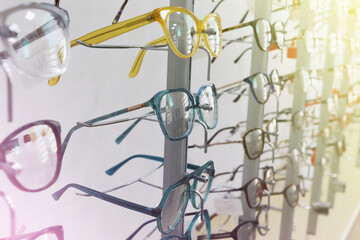 Optics salon. Optical store. Beautiful colored Eyeglasses for sale. Stylish modern eyeglass frame