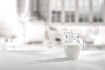 Glass of fresh milk and kitchen interior 