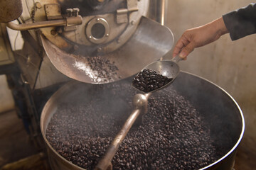 Close-up of a woman roasting coffee beans