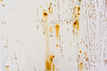 Background of rusty metal wall covered with paint peeling off