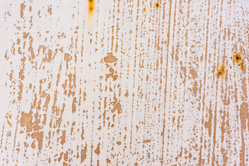 Background of rusty metal wall covered with paint peeling off