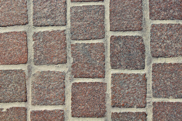 Old square paving stones. Close-up. Top view. Background. Texture.