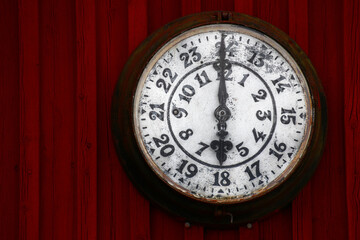 Old clock on a red wooden wall