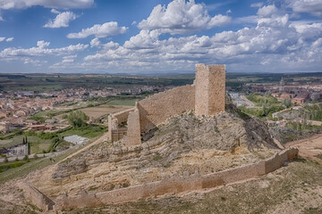 Fototapeta na wymiar El Burgo de Osma medieval castle and town aerial view in Castille and Leon, Spain with blue sky on a sunny with cloudy day