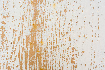 Background of rusty metal wall covered with paint peeling off