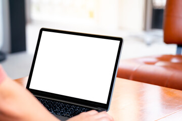 Mockup image of business woman using and clicking on wireless mouse with blank white screen.