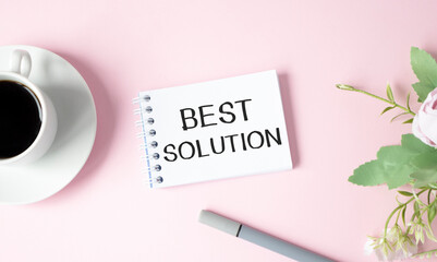 The text, the word Best Solution is written in a notebook lying on a wooden table with a cup of coffee and cookies. Business concept