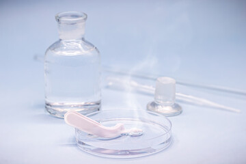 Sulfuric acid in petri dish, melting plastic spoon, corrosive acid in action