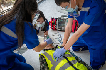 Emergency medical teams are helping unconscious patients by using automated external defibrillators...