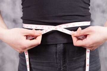 young girl measures abdominal girth