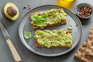 Tasty fresh toast with mashed avocado