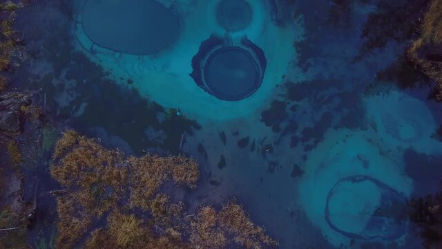 4K Aerial Footage Video of the Autumn Forest and Geyser Lake with Clear Blue Water near the village of Aktash in the Altai Mountains, Russia