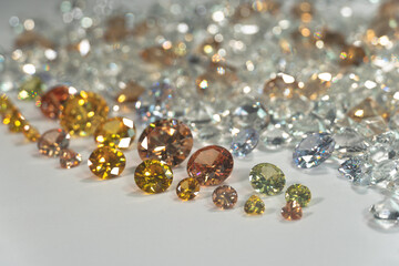 .A group of Golden diamonds arranged in a row in front of white diamonds on a white background..