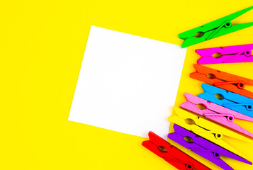 Colorful wooden clothespins with To Do List Sticker on yellow background. Close up, copy space. Minimalism, original and creative photo. Vertical Wallpaper for smartphone.