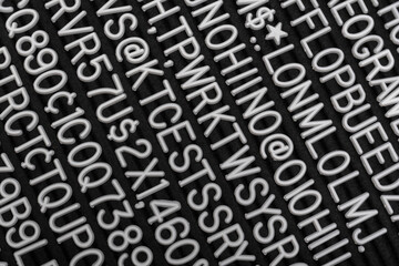 Abstract text background. Passwords, codes, cipher. Random white letters on black background.