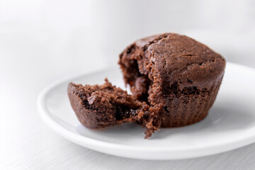 Chocolate muffin on white plate. Homemade cakes cupcakes. Close up