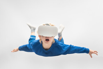 Boy flies in virtual reality glasses. White background. Virtual reality games