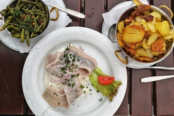 White herrring with fried beans and potatoes, traditional Northern German dish served in restaurant