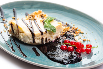 Sponge cake pieces decorated with red currants and mint
